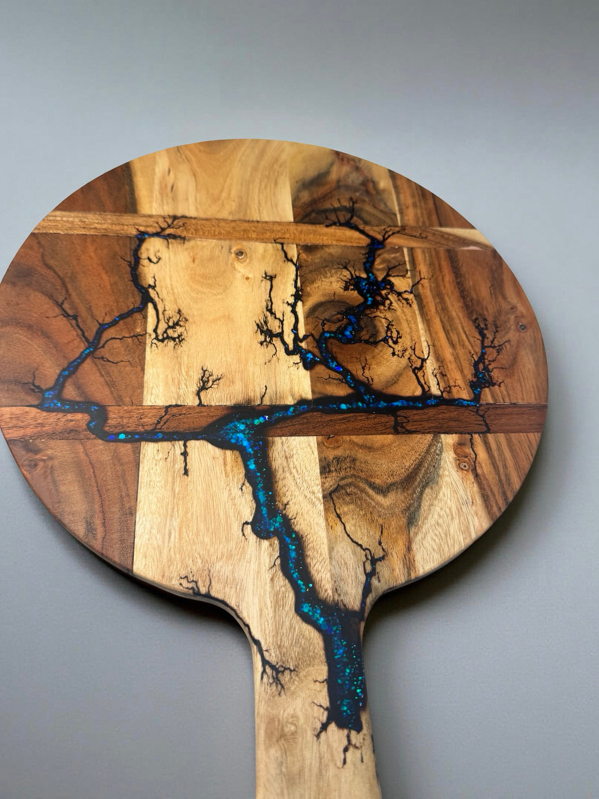 Premium resin cheese board featuring blue sparkle resin inlay through fractal burned acacia timber, artisan serving board Australia, Fractal Flow Designs