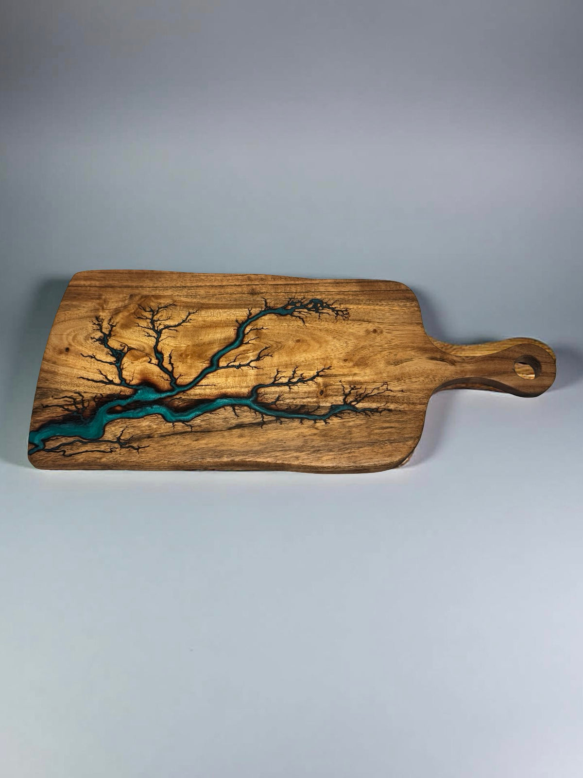 Fractal burned acacia timber paddle with green resin art flowing through the grain, artisan charcuterie serving board Australia, Fractal Flow Designs