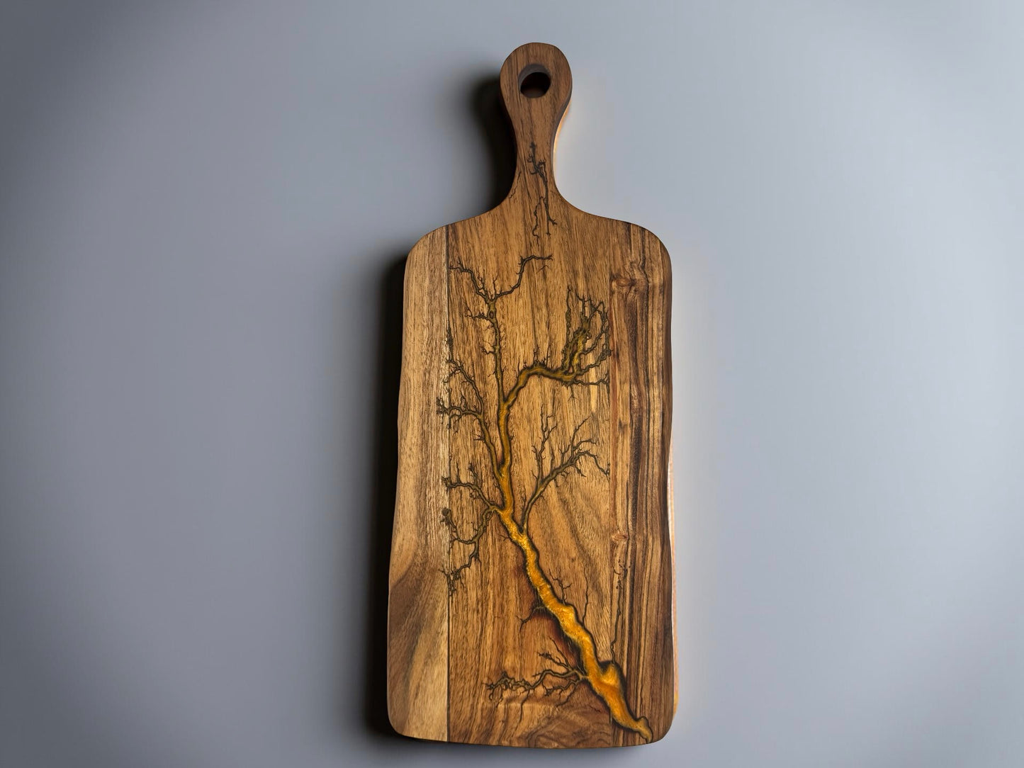 Orange resin paddle cheese board with fractal burning lightning pattern on acacia timber, handcrafted serving board East Gippsland Australia, Fractal Flow Designs