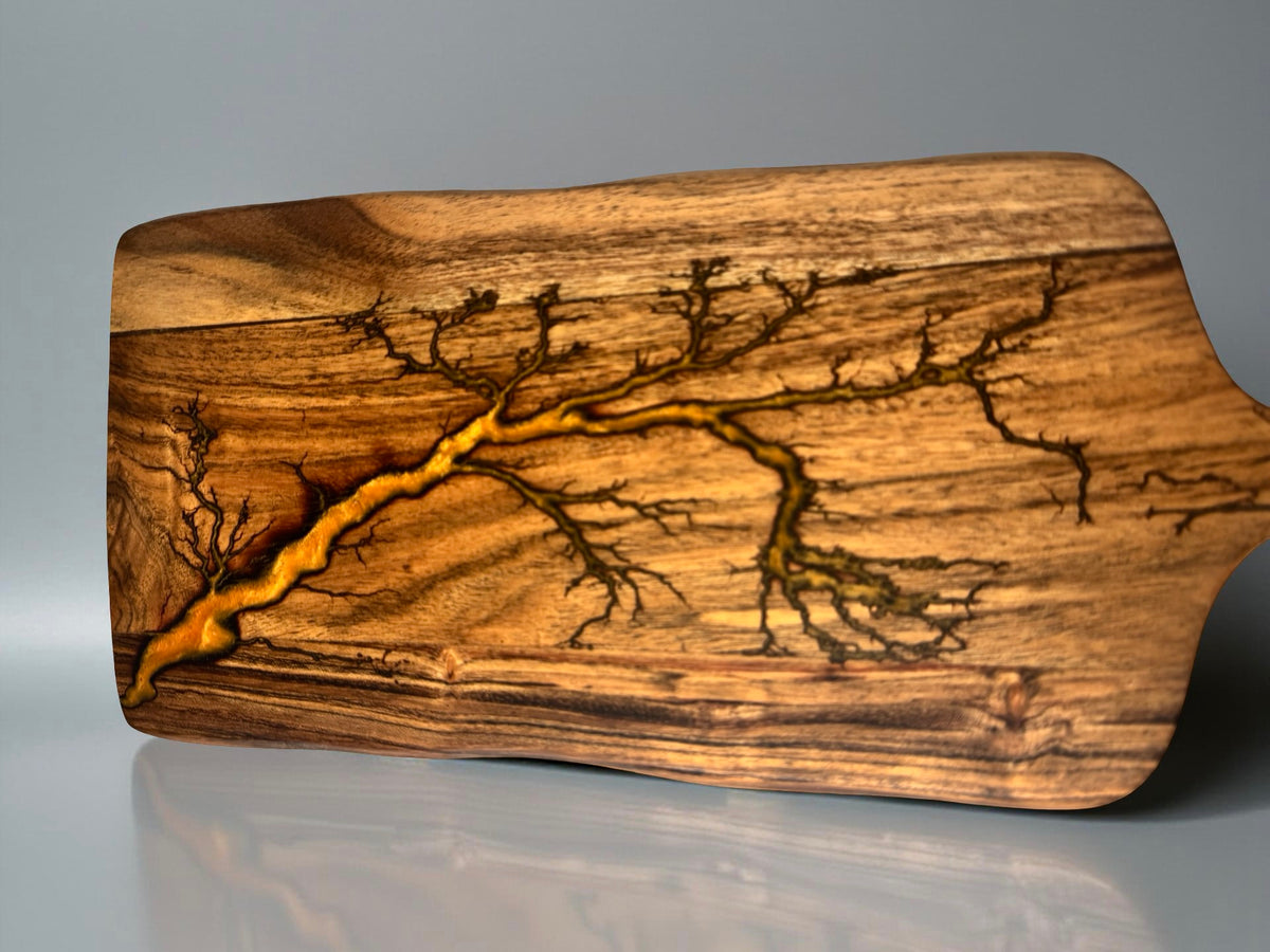 Premium resin paddle cheese board with orange resin inlay through acacia timber after fractal burning process, Australian resin board, Fractal Flow Designs