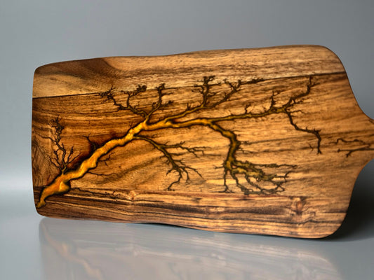 Premium resin paddle cheese board with orange resin inlay through acacia timber after fractal burning process, Australian resin board, Fractal Flow Designs