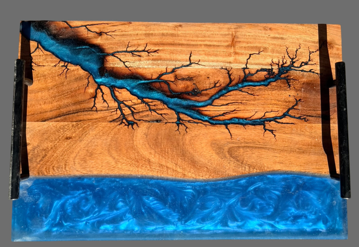 Premium wooden resin board or tray with a bright blue resin river running through the wood, featuring a tree branch pattern and a thick textured blue resin base. Handmade in Australia , perfect gifting item