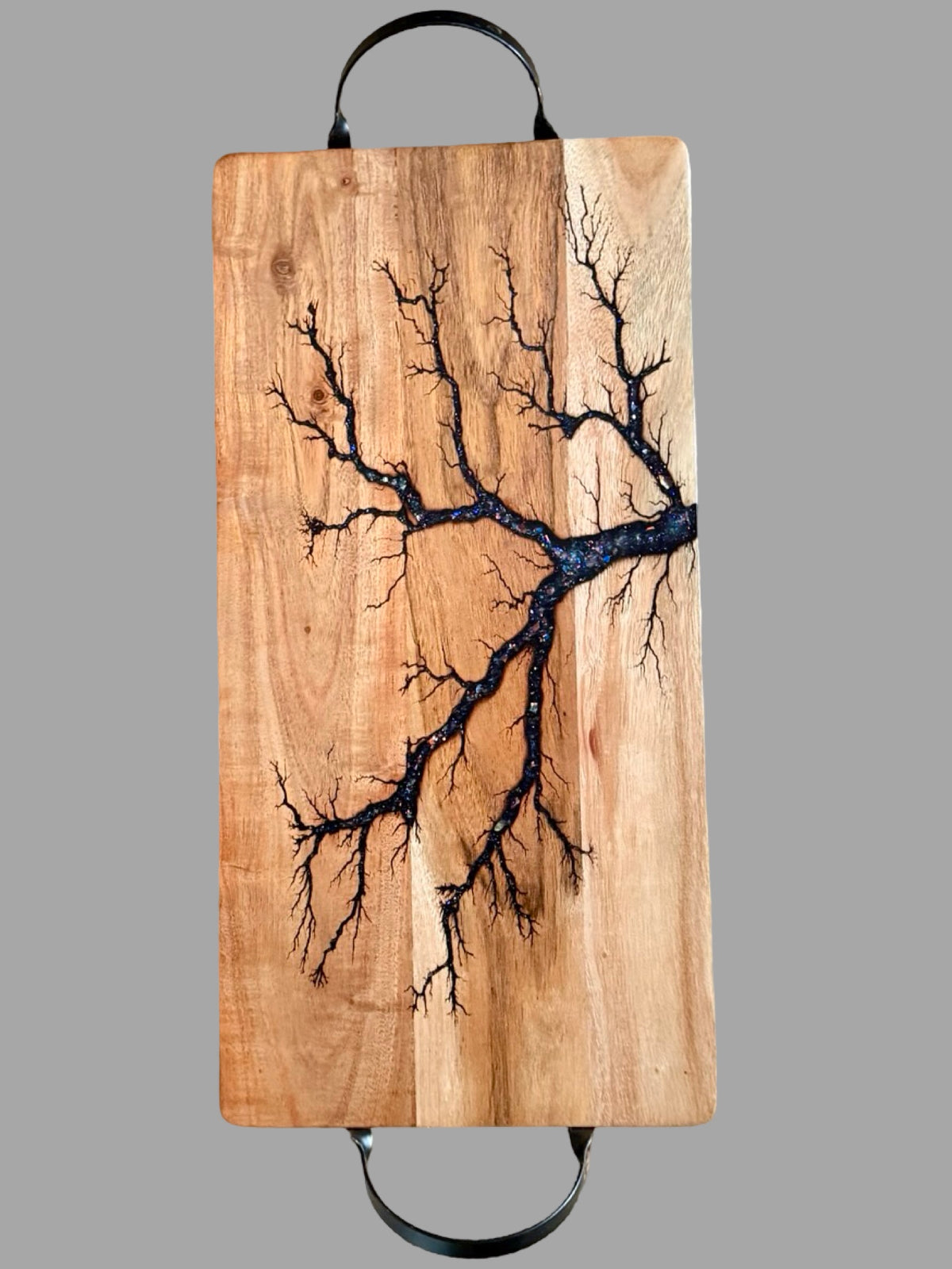 Luxury 500mm acacia serving board with matte black handles, electric blue sparkle resin art and intricate fractal wood burning, handcrafted in Australia